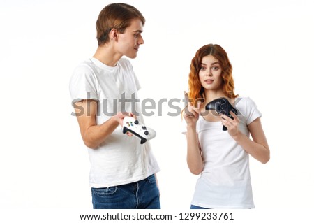 Young people with joysticks on a light background, new technologies                     