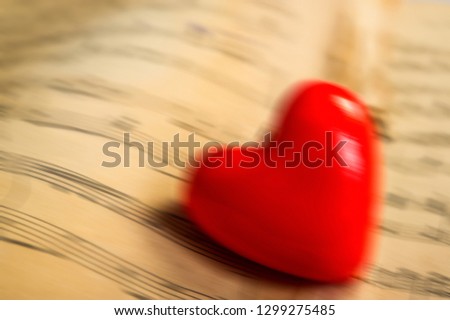 heart lies on the background of notes, blurred background. Web banner for design. For cover design.