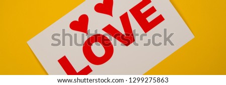 two hearts and the inscription love lies on a yellow background. Web banner for design. 