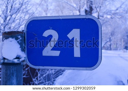 Road sign in winter forest, twenty first kilometer