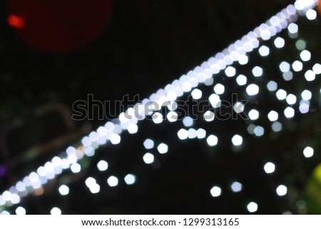 Blurred night life in city. Defocused bright light decorating during festival. Christmas, New Year celebration.