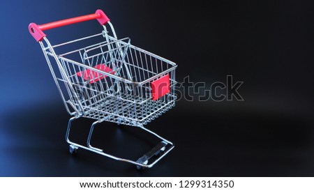 Isolated shopping cart on black background.  Shopping in supermarket idea or concept. 