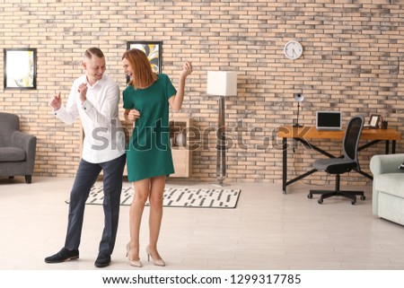 Beautiful couple dancing at home