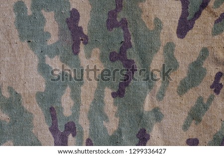 Old camouflage cloth texture. Abstract background and texture for design abd ideas.