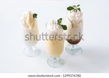 Assorted milkshakes set. Minimal layout. Three glasses on white background.