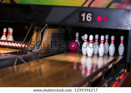 Close up of alley at bowling club. pin bowling alley background. Closeup of ten pin row on a lane, night light and sphere ball . Victory concept competition in a team action game