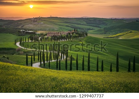 Tuscany landscape in spring fields green meadows Royalty-Free Stock Photo #1299407737