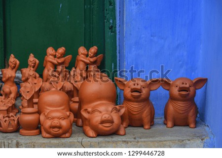 Ceramic pig toys for sale on street at Hoi An Old Town, Vietnam.