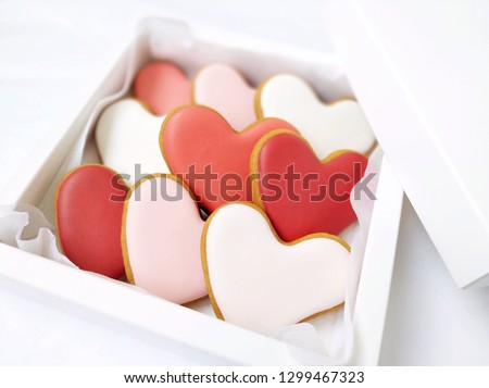 Cookies in a box in the form of baked hearts for Valentine's day. Sweet sweets with love. Gift for Valentine's Day. Valentine day background.
