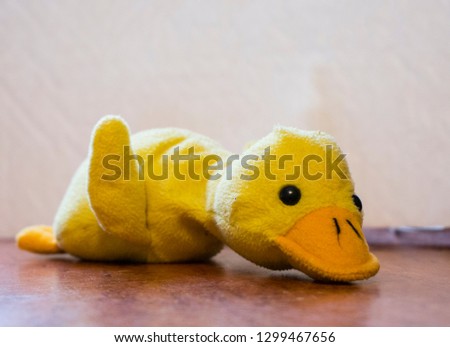 yellow soft duck toy lies