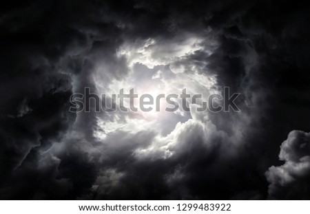 Hole in the Dark and Dramatic Storm Clouds Royalty-Free Stock Photo #1299483922