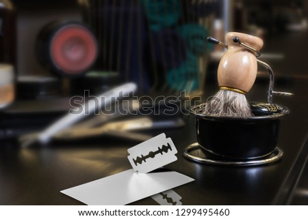 razor with a business card on a background of hairdressing tools