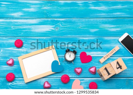 Creative Valentine Day romantic composition flat lay top view love holiday celebration red heart calendar date blue wooden background