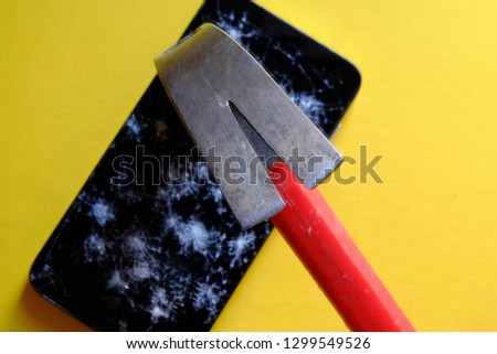 Smartphone is broken with a hammer.