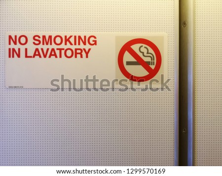 Airplane toilet. Red word No Smoking in lavatory and symbol. Copy space.