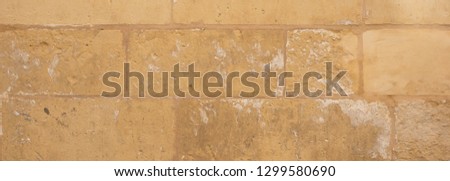 Natural stone background texture, yellow, beige color. Traditional limestone wall facade background in Malta, banner