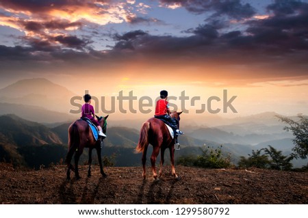 A young cowboy riding a horse, looking at the light of the monks, such as the Buddha