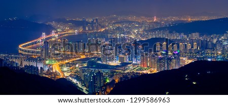 Panorama of Busan cityscape with skyscrapers and Gwangan Bridge illuminated at night. Busan. South Korea Royalty-Free Stock Photo #1299586963