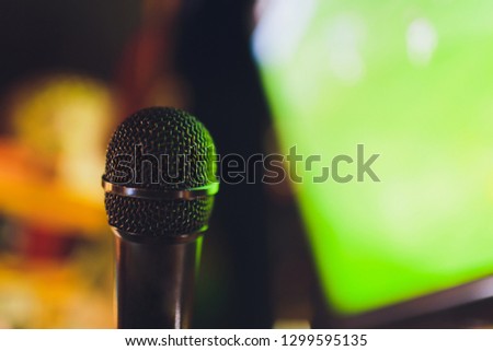 Microphone for commentator with sport football field stadium background with space for text.