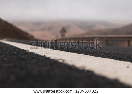 Road Line with Blurry Road in Background, in Fuerteventura Mountains