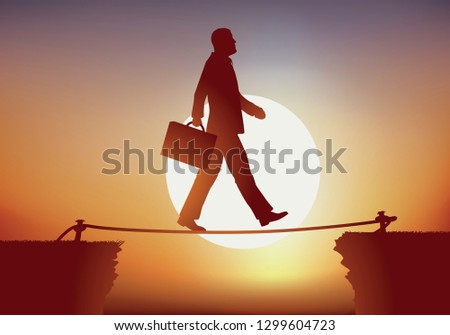 Concept of a businessman sure of himself, who crosses an obstacle while crossing a precipice, balancing on a rope like a tightrope walker