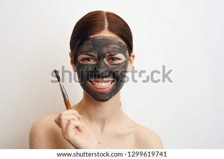 woman smiling in clay mask portrait