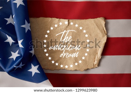 vintage crumpled paper with the american dream lettering and stars on american flag 