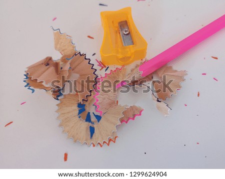 Colored pencils and pencil sharpeners isolated on a white background