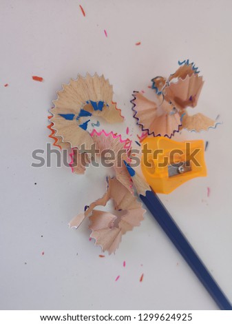 Colored pencils and pencil sharpeners isolated on a white background