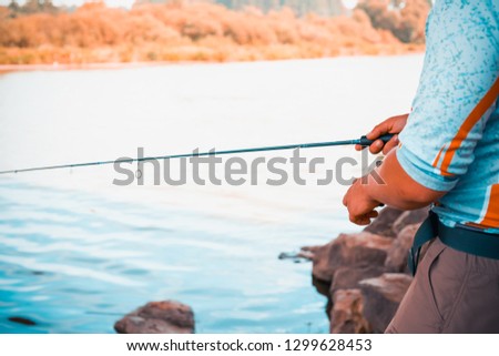 the fisherman is fishing on the lake
