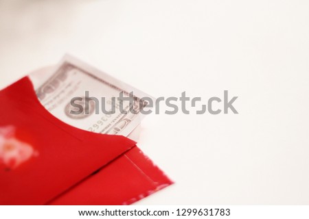Bank note in red envelope, white background
