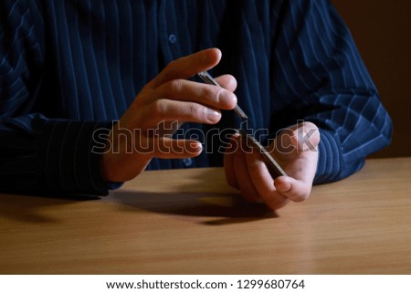 Man in darkness holding a set of playing cards and shuffle them, business strategic competition concept