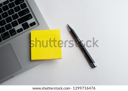 Notebook with black pen, Colorful notepads on the desk, Glasses on the desk with pen and cup of coffee, Computer keyboard with colorful note stick