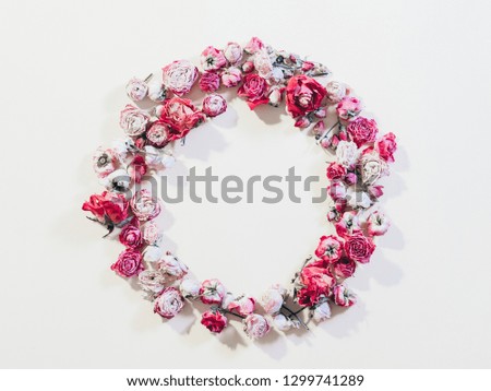 Festive flower composition. Congratulation concept. Dried rose wreath on ivory background.