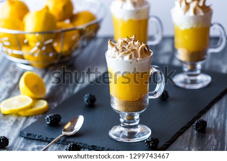 Close up display of lemon meringue pie dessert glasses ready to eat.