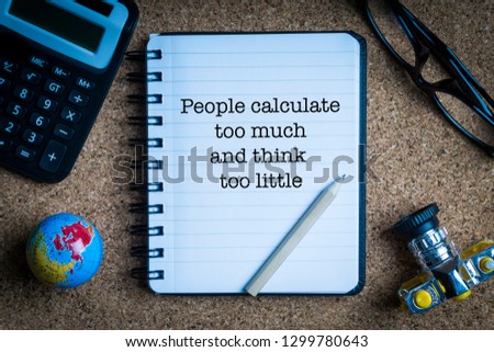 PEOPLE CALCULATE TOO MUCH AND THINK TOO LITTLE inscription written on book with globe,eyeglasses, calculator, camera, pencil and vase on wooden background. Business and education concept