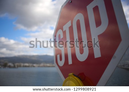 A stop sign near the sea.