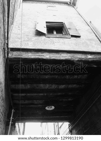 Alley and window. Black and white photo.