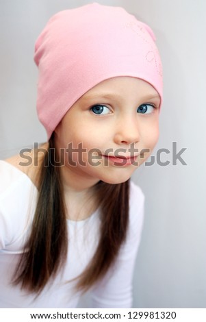 Portrait of a cute little girl smiling, portrait over light grey background