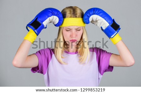 Keep calm and get rid of headache. Beat headache. Girl boxing gloves tired to fight. Strong woman suffer pain. Girl painful face embrace head with boxing gloves. Headache remedies. Headache concept.