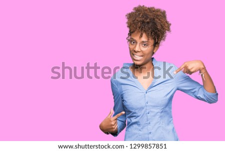 Beautiful young african american business woman over isolated background looking confident with smile on face, pointing oneself with fingers proud and happy.