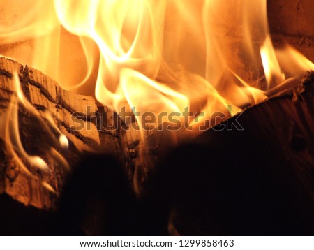 Red hot flames fire texture. Branches and twigs being burnt in a campfire background