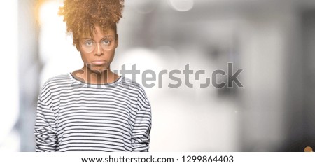 Beautiful young african american woman wearing glasses over isolated background depressed and worry for distress, crying angry and afraid. Sad expression.