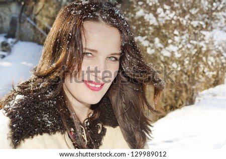smiling woman with snow on her hair