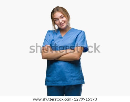 Young caucasian nurse woman wearing surgeon uniform over isolated background happy face smiling with crossed arms looking at the camera. Positive person.