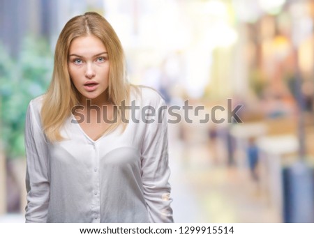 Young caucasian woman over isolated background afraid and shocked with surprise expression, fear and excited face.