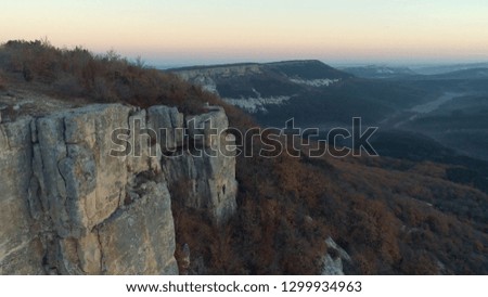 Aerial view of top of the mountains with trees and forest. Shot. Beautiful view of nature at the sunset