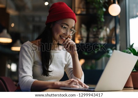 Asian woman freelancer typing on keyboard using laptop computer, working project in office. Portrait of skilled copywriter at workplace Remote job. Smiling university student learning language online	