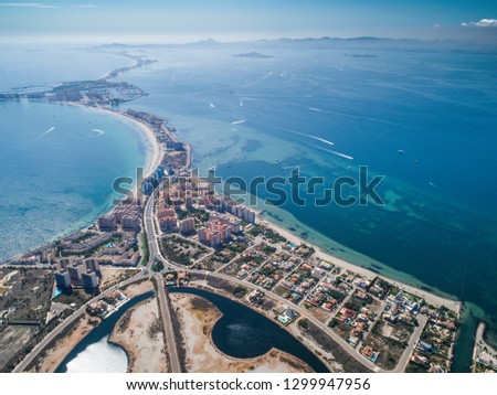 Aerial photo of buildings, villas and the beach on a natural spit of La Manga between the Mediterranean and the Mar Menor, Cartagena, Costa Blanca, Spain. 11