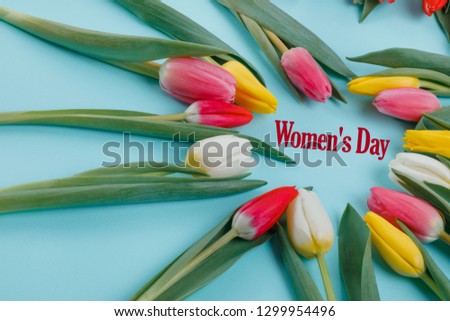 Postcard for Women's Day. Spring tulips frame on background, top view.